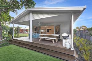 a pavilion with a picnic table on a deck at Reflections Evans Head - Holiday Park in Evans Head