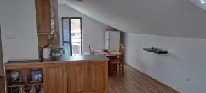 a kitchen with a counter top and a table at Apartmani Amira Trebinje in Trebinje