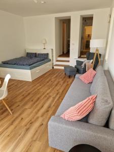 a living room with a couch and a bed at Beethoven29 / Studio mit Garten direkt in Krems in Krems an der Donau