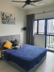 a bedroom with a blue bed with a ceiling fan at 3 bedrooms maxim link MRT cheras kuala lumpur in Kuala Lumpur