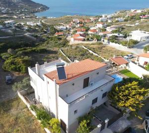 an aerial view of a white building with a red roof at Seafront Villa Nefeli in Keratea