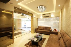 a living room with a couch and a table at Hotel Columbus in Mumbai