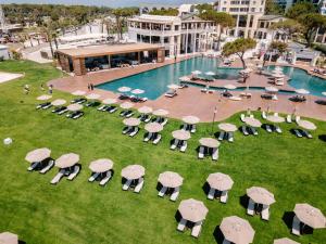 an overhead view of a pool with chairs and umbrellas at Rixos Park Belek - The Land Of Legends Access in Belek