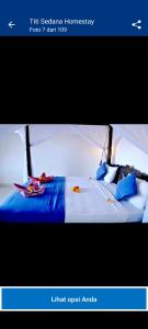 ein Bild eines Bettes in einem Zimmer in der Unterkunft Titi Sedana Homestay in Amed