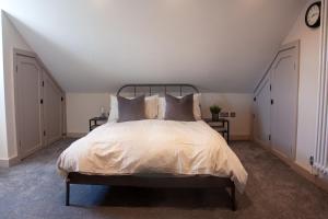 a bedroom with a large bed in a attic at Oxford Street Grand Apartment in Southampton