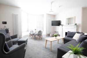 a living room with two couches and a table at Oxford Street Grand Apartment in Southampton