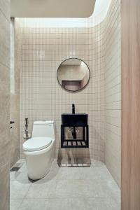 a bathroom with a white toilet and a mirror at Yung An Business Hotel in Dounan