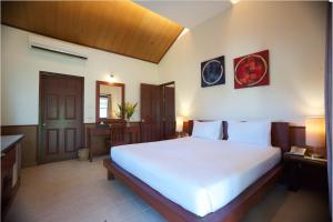 a bedroom with a large white bed in a room at Pinnacle Samui Resort in Mae Nam