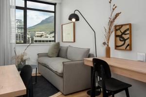 a living room with a couch and a table at The Carrington Aparthotel by Totalstay in Cape Town
