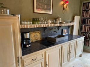 a kitchen with a sink and a counter top at Gîte du Manoir in Monnaie +15 photos