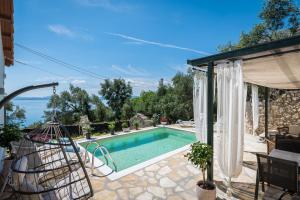a villa with a swimming pool and a patio at Alkinoi Seaview Villa with Private Pool by Konnect, Nisaki in Nisakion