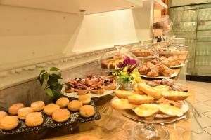 a buffet line with different types of pastries and desserts at Hotel Okinawa in Rimini