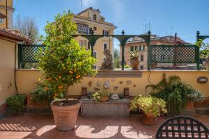 a courtyard with a fountain and trees and buildings at Terrazza San Saba in Rome