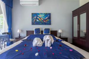 two elephants sitting on a bed with flowers on it at Chalong Palm Residence in Chalong 