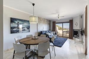 a dining room and living room with a table and chairs at Buena Vista G5 in Atamaría