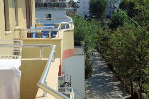a balcony of a building with blue and white at King's Star Hotel in Velipojë +2 photos