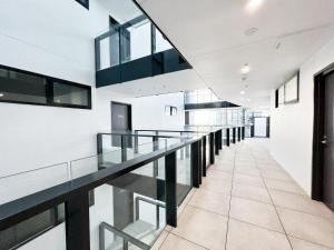 a hallway with glass railings in a building at Panorama Apartment Walk to Box Hill Central by GoodLive in Box Hill