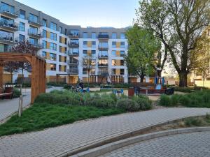 a park with a playground in front of a building at JR Smolna in Poznań