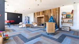 a living room with wooden floors and a fireplace at TERRESENS - Les Roches Blanches in Combloux