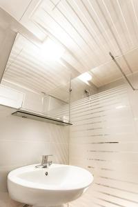 a bathroom with a white sink and a skylight at Hotel Bernoui Seoul in Seoul