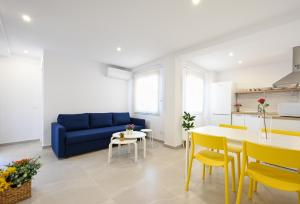 Una sala de estar con un sofá azul y una mesa. en New 2 bedroom beach and city center - Ruiz Vertedor by 10ToSea, en Fuengirola 7 fotos más