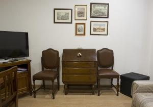 a room with a desk and two chairs and a television at San Marco - Rialto with WIFI in Venice