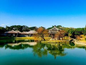 un estanque en un parque con un edificio chino en ピースリー安里301, en Tomari