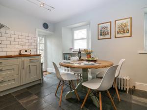 a kitchen with a table and chairs in a room at Dunira in Cupar