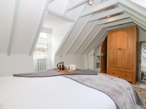 a bedroom with a white bed with a tray on it at Dunira in Cupar