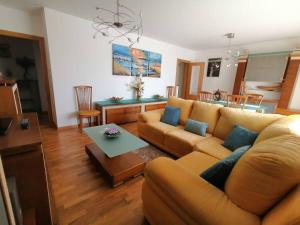 a living room with a couch and a table at Apartamentos Vila Verde T3 in Ponte de Lima
