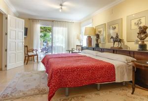 a bedroom with a bed with a red blanket at Xenofilia 3 in Moraira +34 photos