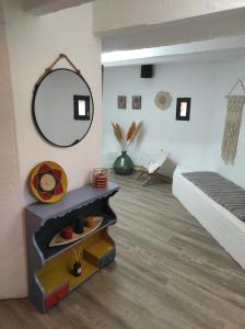 a bedroom with a bed and a mirror on the wall at Casa Sa Posidonia -POSIDONIA SURF & STAY- in Ciutadella