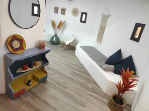 a living room with a couch and a mirror at Casa Sa Posidonia -POSIDONIA SURF & STAY- in Ciutadella