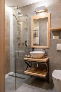 a bathroom with a sink and a glass shower at Willa Malinowa in Zakopane