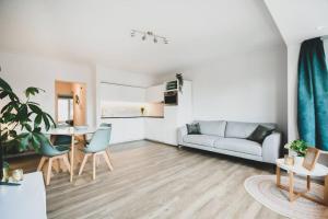 a living room with a couch and a table at 2-slaapkamer app. Middelkerke in Middelkerke