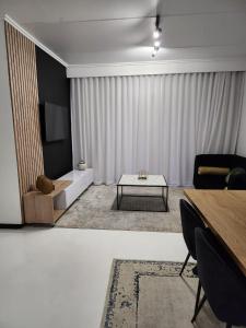 a living room with a table and a couch at Manelo in Fourways in Fourways