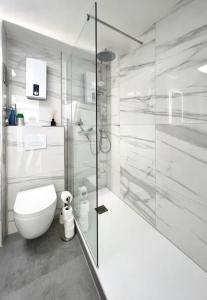 a white bathroom with a toilet and a shower at Schickes Apartment in City Lage B7 in Karlsruhe