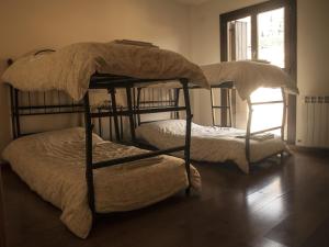 two bunk beds in a room with a window at Casa Mallos de Agüero in Agüero +34 photos