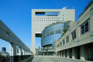 a large white building with a blue roof at The Mark Grand Hotel in Saitama