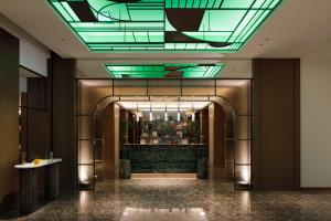 a lobby with a building with a green ceiling at The Mark Grand Hotel in Saitama