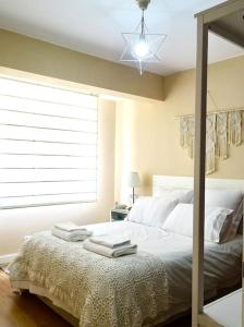 ein Schlafzimmer mit einem Bett mit Handtüchern darauf in der Unterkunft Piso Riazor 4 habitaciones in A Coruña