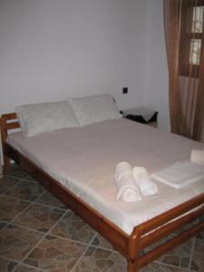 a bed with white sheets and folded towels on it at Stelios house in Theologos