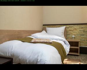 Ένα ή περισσότερα κρεβάτια σε δωμάτιο στο ASA Hotel