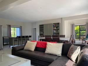 a living room with a couch and a dining room at The Baobab in Northriding