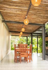 a dining room with a table and chairs and lights at Chobwe Lodge in Chelston