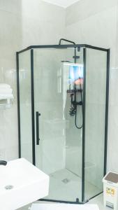 a glass shower in a bathroom with a sink at Chobwe Lodge in Chelston