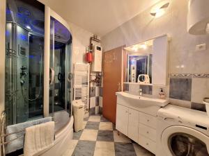 a bathroom with a shower sink and a washing machine at Apartment Taya in Piran