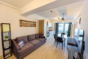 a living room with a couch and a table at MDApartment in Infinity Beach Resort- Parking in Mamaia