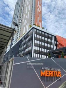 a large building with a sign in front of it at JOVIAL Modern Cozy Homestay `Meritus Perai in Perai