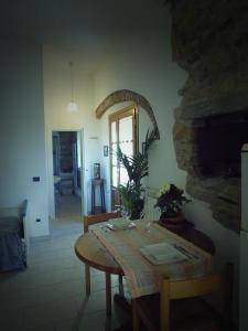 a dining room with a table and a mirror at Villa il Poderino in Marina di Campo